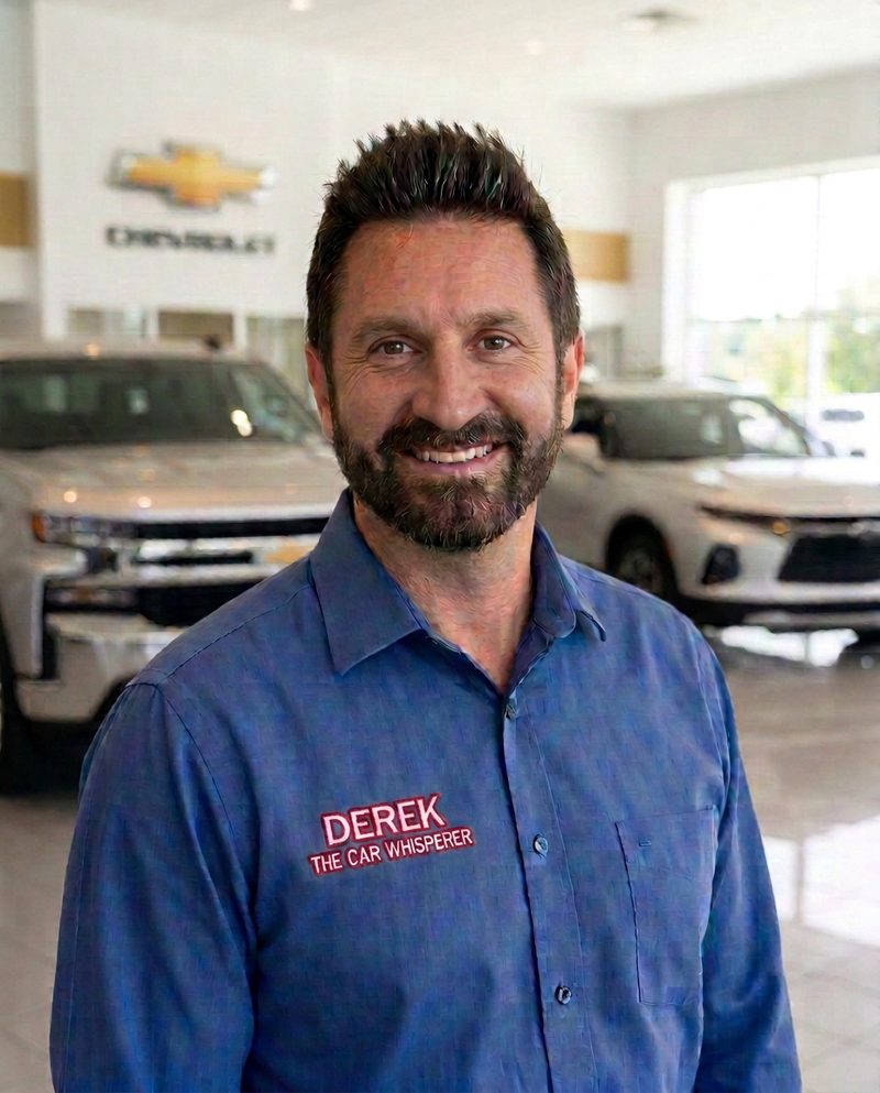 Derek the Car Whisperer — Chevrolet showroom portrait in a blue shirt with Derek name patch